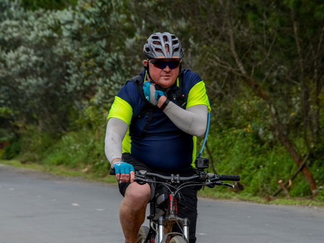 Cyclist fixing his helmet