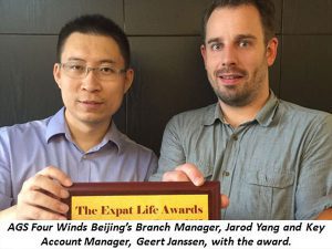 2 men posing with the expat life award