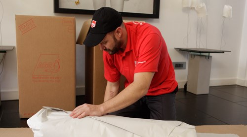 AGS London Removals employee busy with packaging.